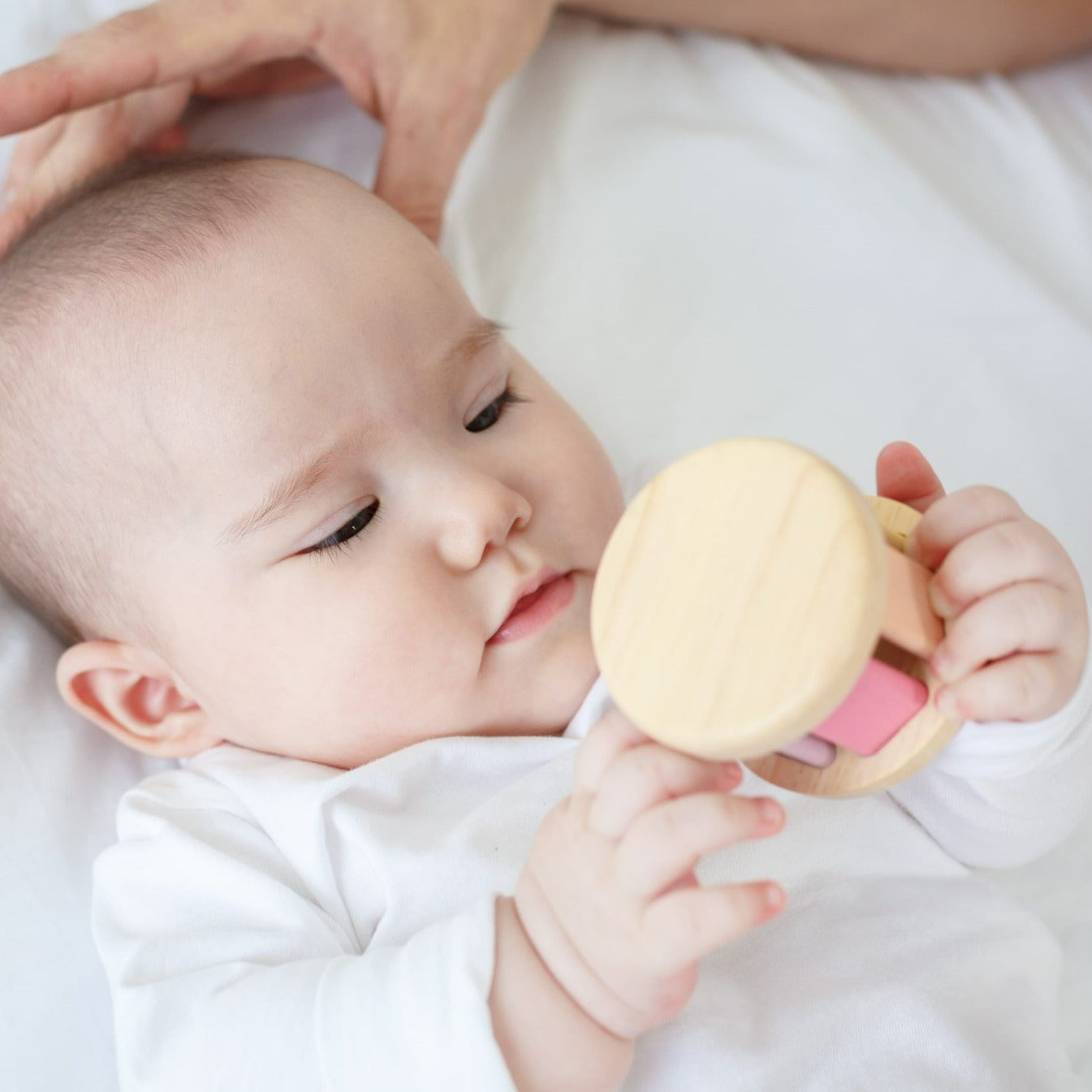 This toy creates sounds when rolled. Stimulates sight and sound.
