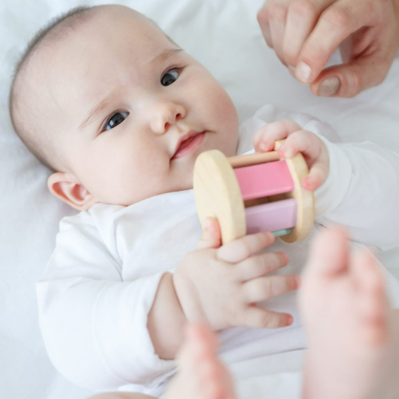 This toy creates sounds when rolled. Stimulates sight and sound.
