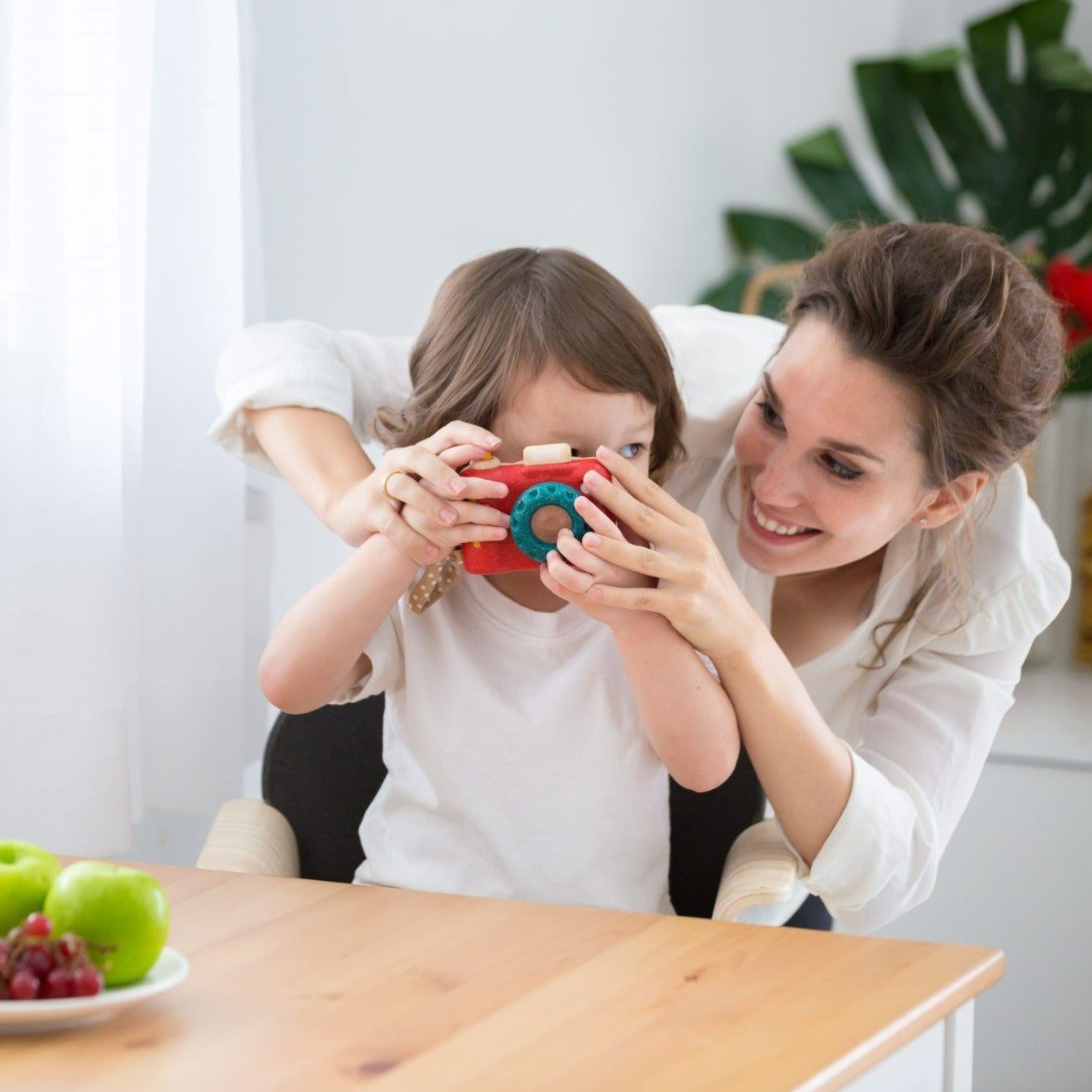 The My First Camera is crafted with PlanWood(TM) a PlanToys material made from surplus sawdust that results in a more flexible water-resistant wood and is pigmented with water-based and natural dyes that are free from harmful chemicals.