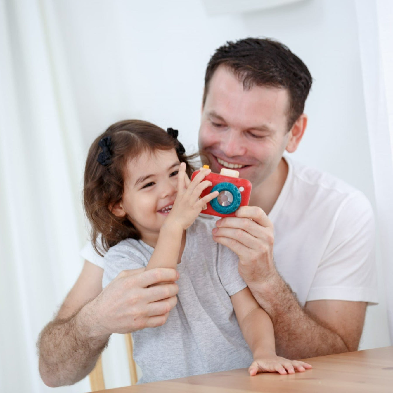 The My First Camera is crafted with PlanWood(TM) a PlanToys material made from surplus sawdust that results in a more flexible water-resistant wood and is pigmented with water-based and natural dyes that are free from harmful chemicals.
