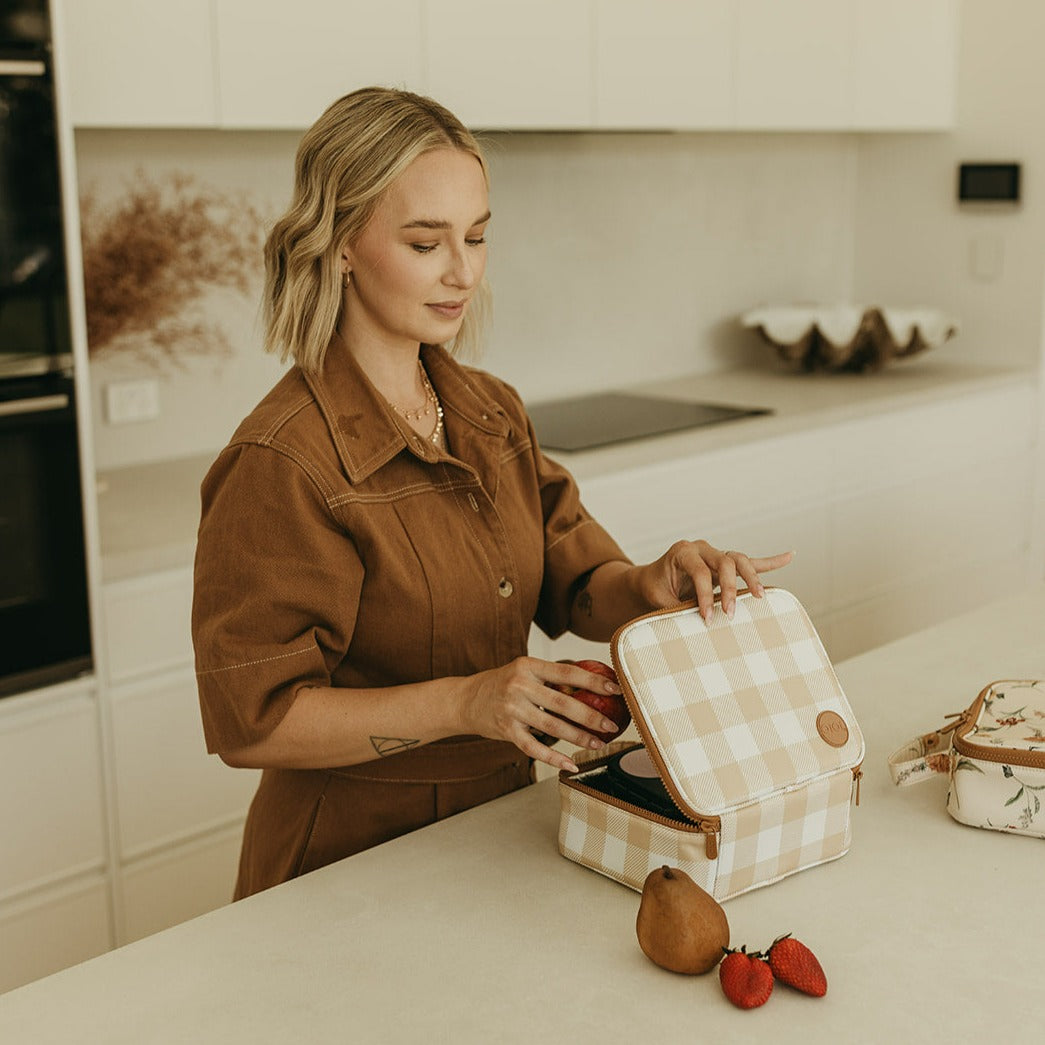 a mother preparing lunch with her beige gingham mini insulated lunch bag